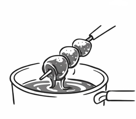 飴にくぐらせるいちご飴の製造工程